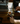 Person preparing La Marzocco coffee using a manual espresso machine on a wooden surface.