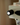 Close-up of a coffee machine with a black knob on a beige background