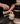 Barista pouring milk into a coffee cup with latte art in a kitchen setting